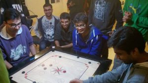Students playing Carom